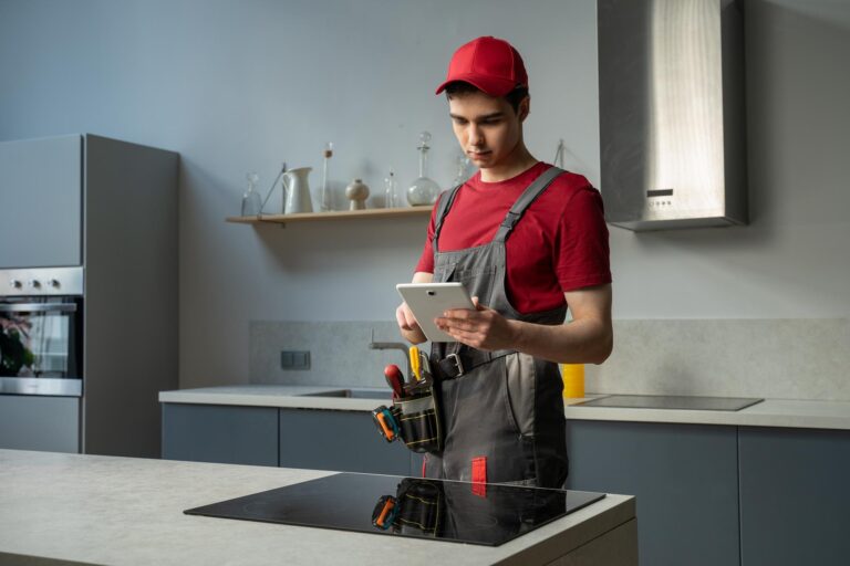 skilled technician red cap gray overalls is diligently working repairing modern 353017 3003
